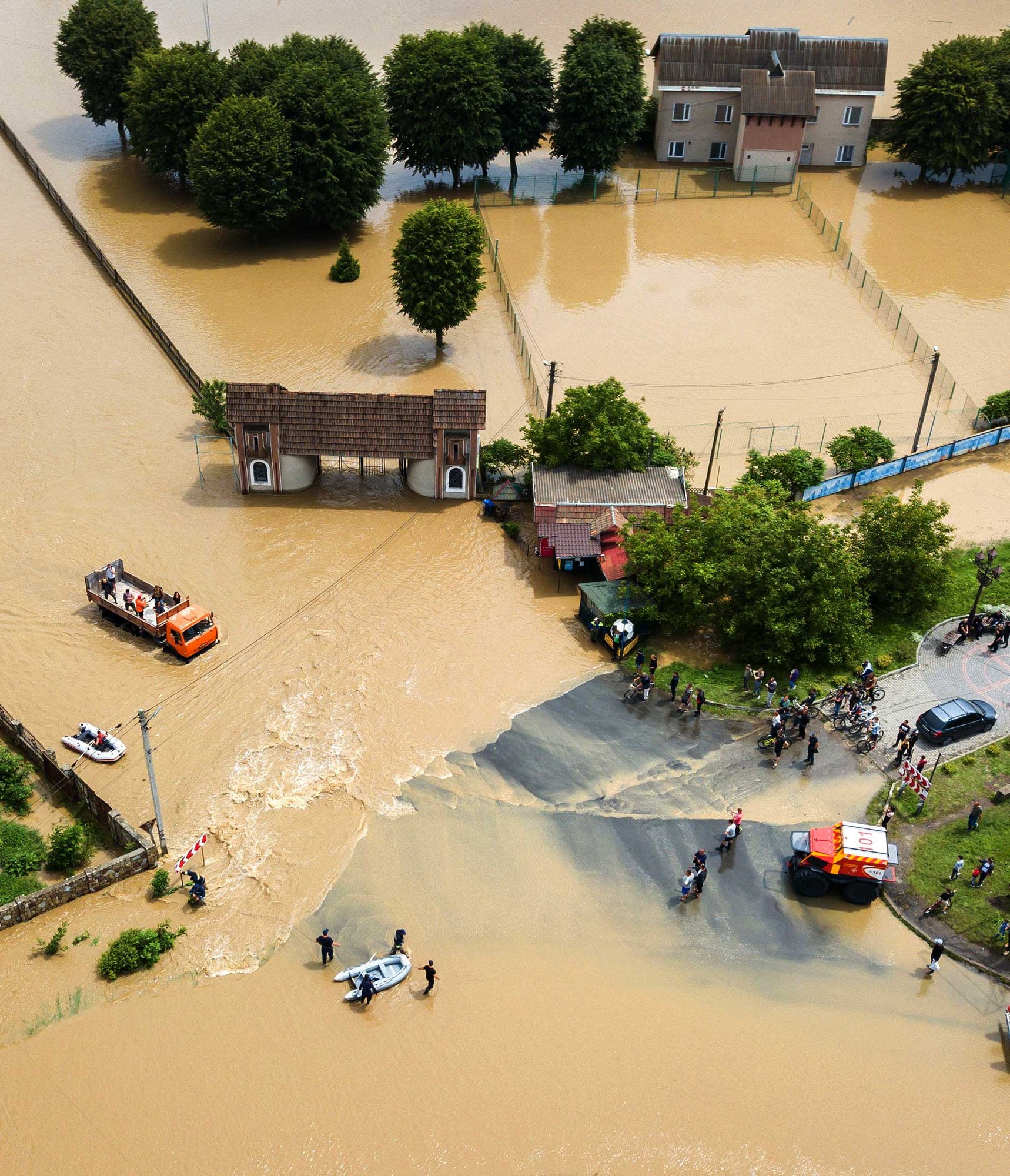 Aerial view of flooded town center with rescue operations