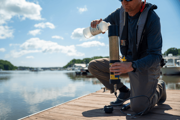 hydrologist calibrating a water quality sonde in the field